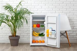 Open White Refrigerator With Food and Drinks in Modern Kitchen photo