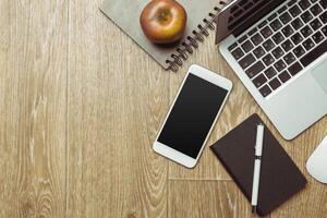 Office table with smartphone on it. View from above photo