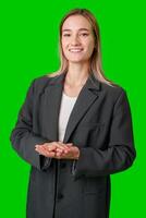 Woman in Grey Blazer Smiling With Hands Clasped in Front of Green Screen photo