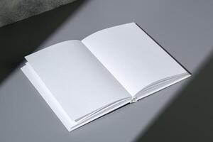 Blank open notepad on gray background studio shot photo