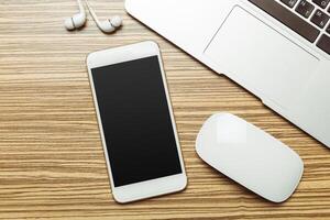 Office table with smartphone on it. View from above photo