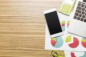 Office table with smartphone on it. View from above photo