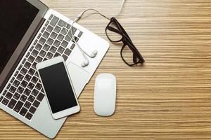 Office table with smartphone on it. View from above photo