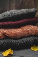 Stack of cozy knitted sweaters photo