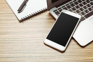 Office table with smartphone on it. View from above photo