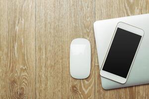 Office table with smartphone on it. View from above photo