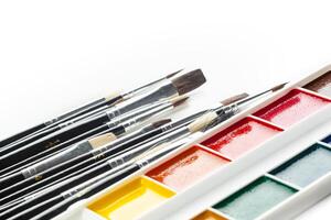 Set of watercolor paints and paintbrushes photo