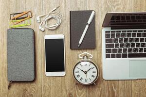 Office table with smartphone on it. View from above photo