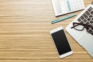 Office table with smartphone on it. View from above photo