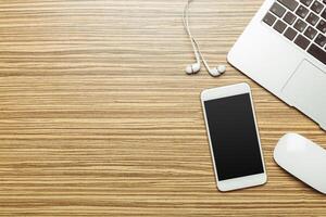Office table with smartphone on it. View from above photo