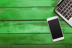 Office table with smartphone on it. View from above photo