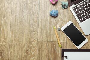 Office table with smartphone on it. View from above photo