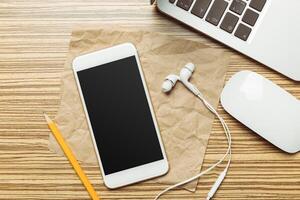 Office table with smartphone on it. View from above photo
