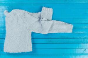 Stack of cozy knitted sweaters photo