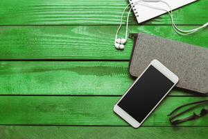 Office table with smartphone on it. View from above photo