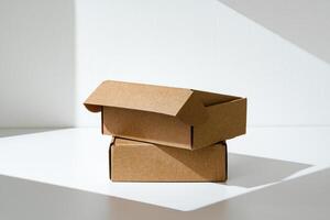 Freshly packed cardboard boxes resting on a white surface, illuminated by soft natural light photo