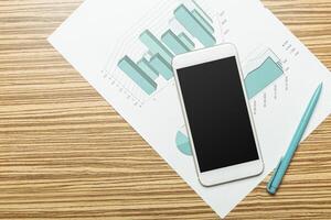 Office table with smartphone on it. View from above photo