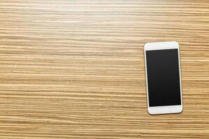 Office table with smartphone on it. View from above photo