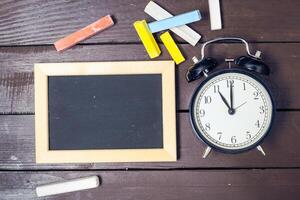 Small blackboard on old wood background photo