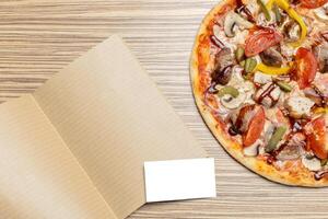 Pizza with blank paper with copy space photo