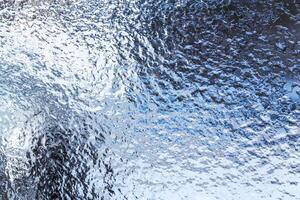 Frozen ice pattern on glass photo