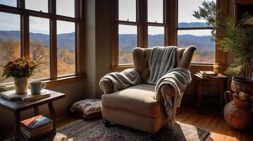 A chair sits in front of a window overlooking the mountains photo