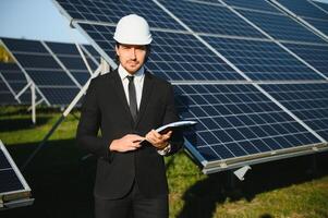 The solar farm, solar panel with engineer check the operation of the system, Alternative energy photo