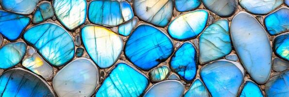 Bright flashes of blue and green in macro shot of polished blue labradorite with fine crystal details photo
