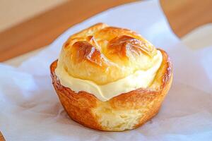Delightful homemade muffin with a creamy cream cheese center on parchment paper photo