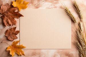 Rustic minimalist wedding invitation mockup with autumn leaves and wheat on beige background photo