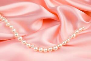 Elegant satin fabric draped gracefully with a string of pearls in soft pastel hues creating a luxurious atmosphere photo