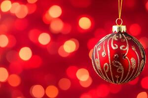 Elegant glass Christmas ornament with intricate red and gold design against a sparkling red bokeh background photo