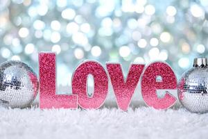 Disco-themed word Love in glittery bubble letters with a pastel background and soft bokeh effects photo