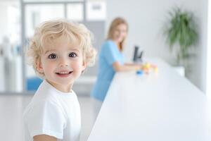 Cheerful child at the reception desk of a pediatric clinic during a bright morning visit photo