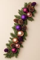 Festive border of green pine branches adorned with colorful ornaments and pine cones on a warm beige background photo