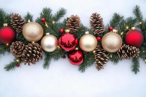 Colorful Christmas tree garland featuring red and gold ornaments with pine cones on a bright white background photo