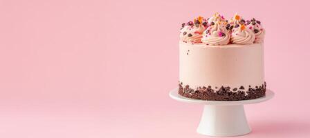 A delightful festive dessert display featuring a beautifully decorated cake on a pink background photo