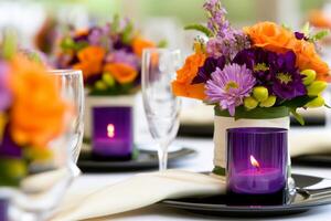 Elegant dinner setting with purple candles and orange floral arrangements for a sophisticated atmosphere photo