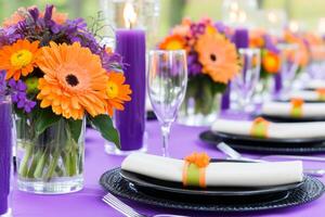 Elegant dinner setting with purple candles and vibrant floral arrangements for a sophisticated dining experience photo