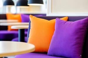 Cozy cafe interior with purple chairs and orange cushions in a warm setting perfect for relaxation photo
