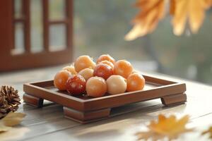 Traditional Korean dried fruit display featuring jujubes and persimmons with autumn decor in a cozy setting photo
