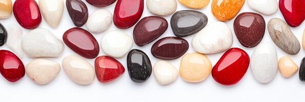 A flat lay of smooth red and cream stones creating a warm and cozy aesthetic on a light background photo