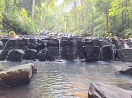 Blurred image of a waterfall in the forest photo