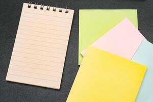 Top view of notebook. Blank paper notepad on office desk table with keyboard and other supplies. Blank notebook page for input the text. copy space, flat lay. photo
