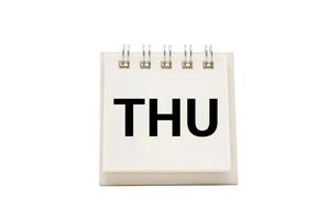 THU text on desk calendar with clipping path isolated on white background. THURSDAY and Calendar concept. photo