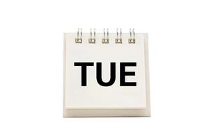 TUE text on desk calendar with clipping path isolated on white background. TUESDAY and Calendar concept photo
