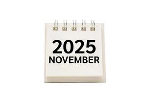 2025 NOV text on desk calendar with clipping path isolated on white background. 2025 NOVEMBER and Calendar concept. photo