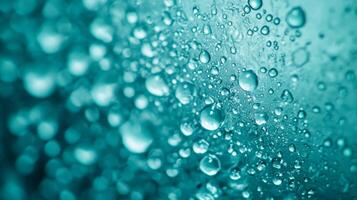 A captivating and mesmerizing abstract background that showcases vibrant turquoise water droplets, which come together to create a tranquil and refreshing atmosphere that draws one in photo
