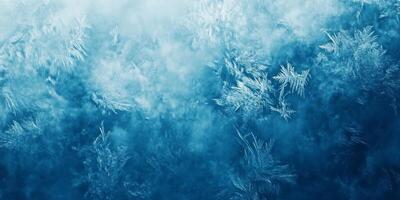 This closeup photograph of frost on a window captures intricate icy formations and a soothing blue hue, creating a chilly winter atmosphere that enhances the beauty of natures frozen artistry photo