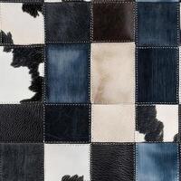 This vibrant patchwork fabric artfully combines classic cow print with modern denim in a stylish and unique design, making it perfect for a wide range of apparel and imaginative sewing projects photo